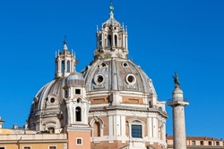 View of the domes of the churches Santa Maria di Loreto and Church of the Most Holy Name of Mary, Trajan's Column at the Trajan Forum on a background of blue sky, Rome, Italy