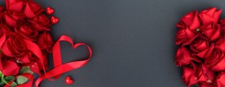 Red buds of valentines day festive roses with hearts on black, web banner format