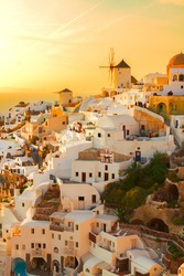 famouse pink and orange sunset of Oia with windmill, Santorini