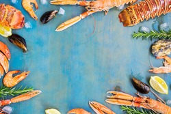 Fresh seafood flat lay frame with copy space on blue background