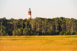 Red and White striped lighthouse beacon situated on Assategue Island Maryland