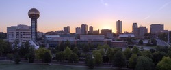 Knoxville city skyline is backlit by the orange hues of sunrise