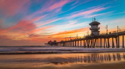 Incredible colors of sunset by Huntington Beach Pier, in the famous surf city in California
