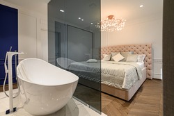 Big luxury elegant classic bathroom connected with bedroom
