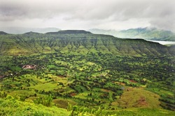 Green valley, aerial view of tropical highlands during rains