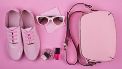 beautiful women's minimal set of fashion accessories on a pink background: shoes, sunglasses, perfume, nail polish and handbag. Ideal for blogs or magazines. Mock up.