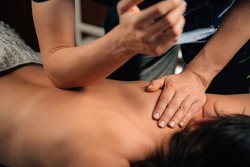 Deep Tissue Massage Therapy. Therapist massaging Woman’s Back, using Elbow Pressure.