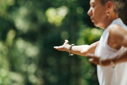 Woman Practicing Tai Chi Chuan Outdoors. Close Up On Hand Position