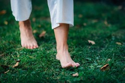 Yoga Woman Walking barefoot, focus on feet.