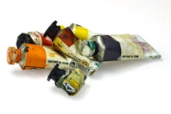 Group of artists paint tubes; used tubes of oil paints, isolated on white ground; differential focus 