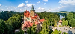 Aerial panorama of Czocha (Tzschocha) medieval castle in Lower Silesia in Poland. Built in 13th century (the main keep) with many later additions. Sumer, sunset light