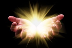 Woman hands cupped holding, showing, or emanating bright, glowing, radiant, shining light. Emitting rays or beams expanding. Religion, divine, heavenly, celestial concept. Black background, front view