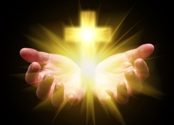 Hands cupped and holding or showing Cross or Crucifix with bright, glowing, shining light. Concept for Christian, Christianity, Catholic religion, divine, heavenly, celestial or god. Black background