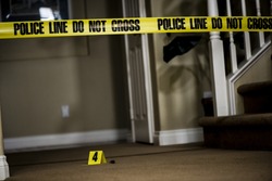 The number 4 crime scene marker on the floor of a house.