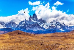 Desert and mountains. The famous ridge Mount Fitz Roy and the Patagonian prairie. Argentine Patagonia. The concept of active and extreme tourism
