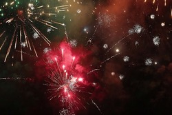 Colorful fireworks blasting in the night sky, evening celebration