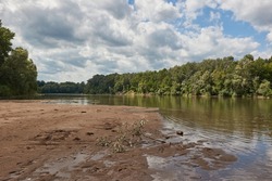 River landscape with sand bank appearing on the shore at low water levles. River Tisza, Hungary