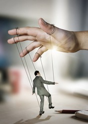 Businessman On Strings. Conceptual photography