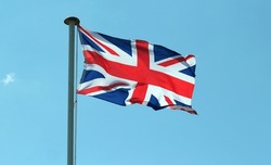 The Union jack flag of Great Britain fluttering in the breeze.