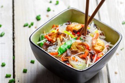 Chinese mix vegetables and rice noodles on old wooden table