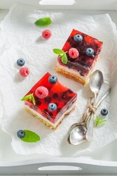 Fruity and homemade cheesecake made of berries and jelly as summer dessert.