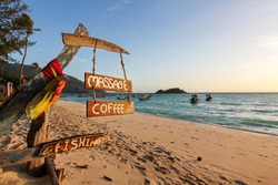 Wood sign of coffee, massage, fishing text at beautiful Thailand travel island 