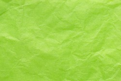 Crumpled wrapping paper in a delicate green color. Background with paper texture effect