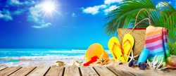 Tropical beach with sunbathing accessories, summer holiday background. Travel and beach family vacation