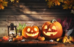Halloween pumpkin head jack-o-lantern on wooden background