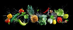 Panoramic wide black background with assortment of fresh vegetables, fruits and water splashes. High resolution collage for skinali