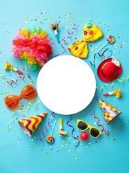 Colorful party items for carnival or birthday party on blue background with copy space