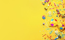 Colorful party items for carnival or birthday party on yellow background
