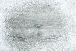 Old wooden board with snow flakes. Christmas background