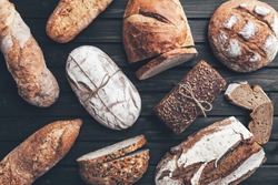 Delicious freshly baked bread on wooden background