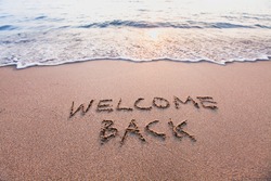 welcome back, text on sand beach, tourism after pandemic concept