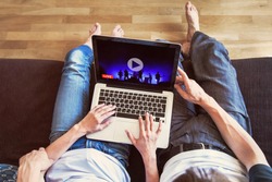 couple watching live streaming online concert at home