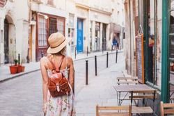 woman tourist walking on the street, summer fashion style, travel to Europe