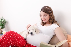 Pregnant woman with her dog at home