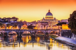 Rome, Italy. San Pietro Basilica and Ponte St Angelo at sunset. 