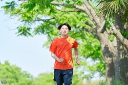 Asian young man running outdoor