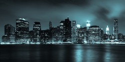 Manhattan skyline by night from Brooklyn bridge park - USA