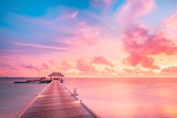 Beautiful sunset beach scene. Colorful sky and clouds view with calm sea and relaxing tropical mood. Beautiful sunset landscape, luxury resort and colorful sky. Artistic beach sunset, wonderful sky