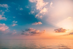 Seascape beach and colorful dream summer sky. Panoramic beach landscape. Empty ocean view, horizon seascape. Orange and golden sunset sky, sun rays, calmness, tranquil relaxing sunlight, summer mood