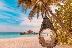 Tropical beach sunset as summer landscape with luxury resort beach palm swing hammock, sand seaside shore for sunset beach landscape. Tranquil beach horizon scenery vacation and summer holiday concept
