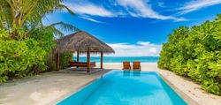 Tropical relax, outdoor tourism landscape. Luxury beach resort with private swimming pool and beach chairs or loungers under umbrellas palm trees, sunny blue sky. Summer travel and vacation background