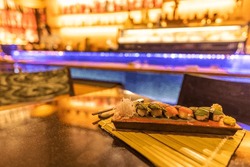 Luxury restaurant closeup delicious Sashimi and sushi Japanese. Traditional food culinary cuisine, lights and decoration, exotic seafood gourmet food, fine dining background. Asian food
