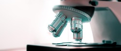 Scientific microscope lenses close up, wide frame with space for text
