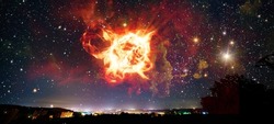 Fantastic night sky over the city with a view of an asteroid explosion in the earth's atmosphere. Elements of this image were furnished by NASA