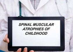 Spinal Muscular Atrophies Of Childhood.  Doctor with rare or orphan disease text on tablet screen Spinal Muscular Atrophies Of Childhood