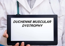 Duchenne Muscular Dystrophy.  Doctor with rare or orphan disease text on tablet screen Duchenne Muscular Dystrophy